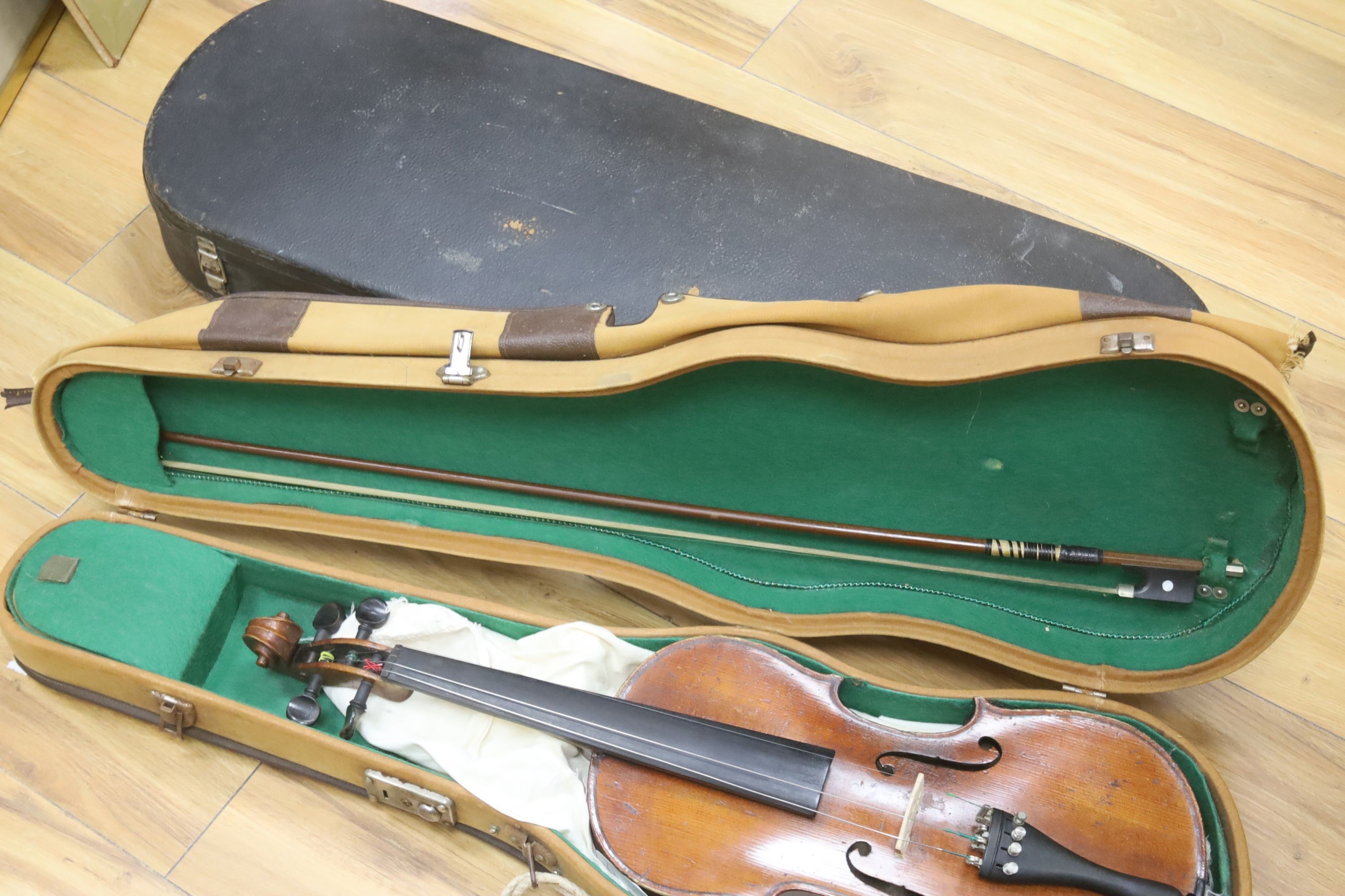 An early 20th century French vioilin, cased with bow and a cased saxon violin